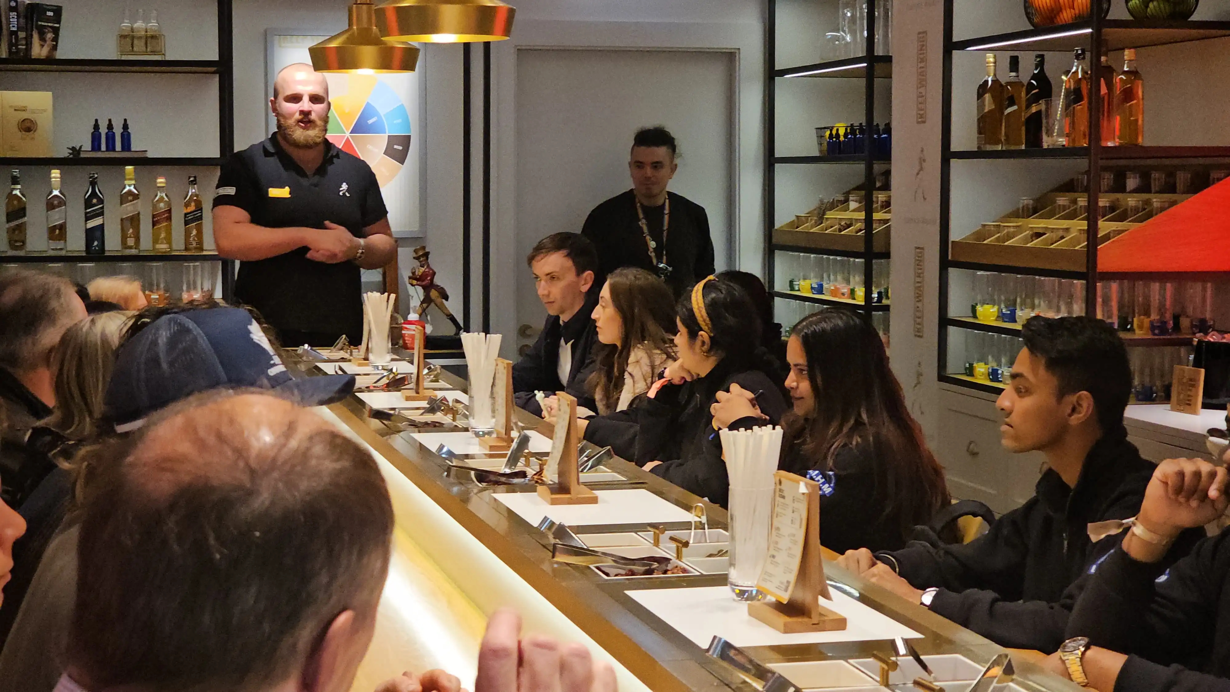 IIHM students participate in an interactive beverage workshop abroad, gaining hands-on learning through a best hotel management college.